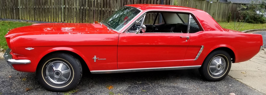A red 1965 Ford Mustang coupe